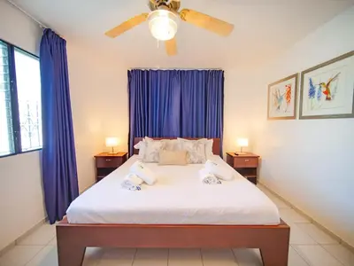 a bedroom with a bed with two stuffed animals on it at COZY 7BR Villa BIG POOL Close to beach in Sosúa