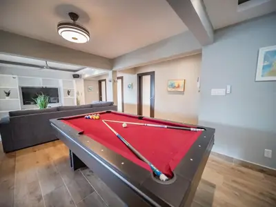 a pool table in a living room with a couch at 4BR Penthouse with Rooftop Pool in Sosua strip in Sosúa
