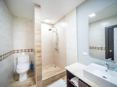 a bathroom with a toilet and a sink at 4BR Penthouse with Rooftop Pool in Sosua strip in Sosúa