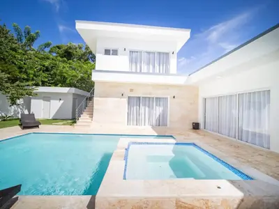 a swimming pool in the backyard of a house at First class 4BR KING SIZE Villa in Sosua town in Sosúa