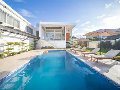 a swimming pool in the backyard of a house at Stylish Luxury Villa in Sosua- 5BR Suites in Sosúa