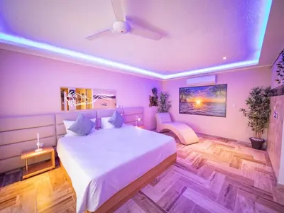 a bedroom with a large white bed and a ceiling at North Coast Luxury Villa in Sosua - 6BR Suites in Sosúa