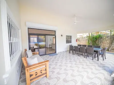 a living room with a dining table and chairs at Modern 5BR Private Villa in Sosua center in Sosúa