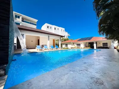 a swimming pool in front of a house at Modern 5BR Private Villa in Sosua center in Sosúa