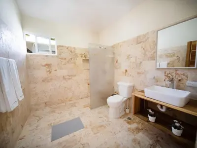 a bathroom with a toilet and a sink at Sun and Soul Caribbean 9BR Villa in Sosua in Sosúa