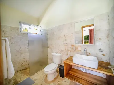 a bathroom with a toilet and a sink at Sun and Soul Caribbean 9BR Villa in Sosua in Sosúa