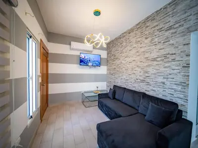 a living room with a couch and a brick wall at 8BR Private Villa in Sosua 2 mins from Nightlife in Sosúa