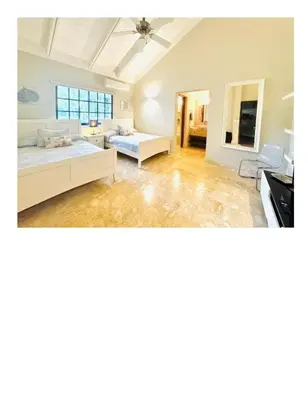 a large room with a bed and a couch at Casa De Campo Beautiful Villa with AC in the all house steps from the beach in La Romana