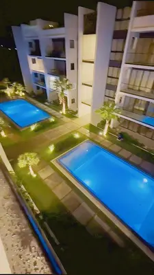 an overhead view of two swimming pools in a building at Caribbean Dream Bayahibe Seaside 3Br Penthouse in Bayahibe