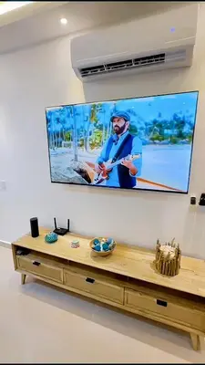 a flat screen tv hanging on a wall at Caribbean Dream Bayahibe Seaside 3Br Penthouse in Bayahibe