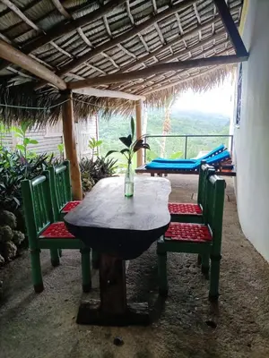 a table and chairs in a room with a view at villa vue mer in Las Terrenas
