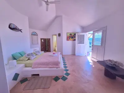 a bedroom with a bed and a table in it at villa vue mer in Las Terrenas