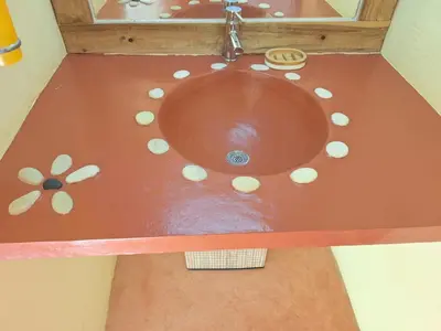 a bathroom with a sink with pills around it at villa vue mer in Las Terrenas
