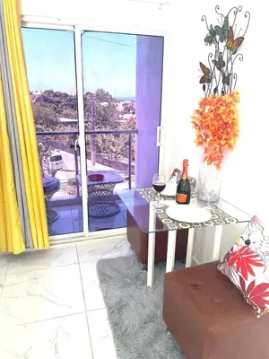 a room with a table and a window with a view at Royal Terrace Queen 1 in San Felipe de Puerto Plata
