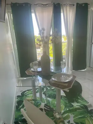 a glass table with a vase on it in a room at Royal Terrace Queen 1 in San Felipe de Puerto Plata
