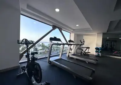 a gym with two exercise bikes and a large window at Beautiful Apartment overlooking Samaná Bay