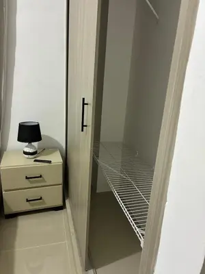 a walk in closet with a night stand and a lamp at Residential hammock 2, next to the brewery in Concepción de La Vega