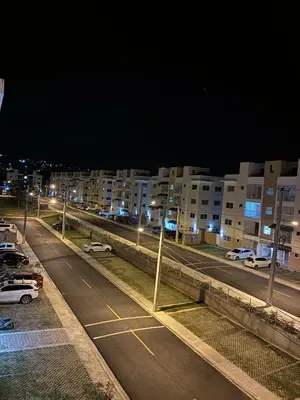 a city street at night with parked cars and buildings at Residential hammock 2, next to the brewery in Concepción de La Vega