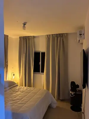 a bedroom with a bed and a window with curtains at Residential hammock 2, next to the brewery in Concepción de La Vega