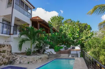 a house with a swimming pool in front of a house at La casa del lago in Cumayasa