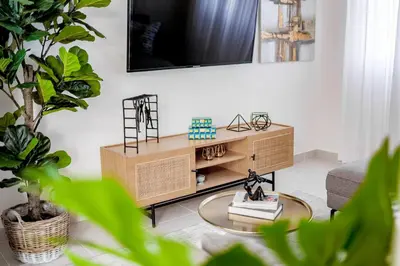 a living room with a tv on a wall at A Tropical Oasis - Vista Canas Villa Vista in Punta Cana