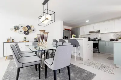 a kitchen and dining room with a dining table and chairs at A Tropical Oasis - Vista Canas Villa Vista in Punta Cana