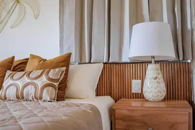 a bedroom with a bed with a lamp on a nightstand at A Tropical Oasis - Vista Canas Villa Vista in Punta Cana