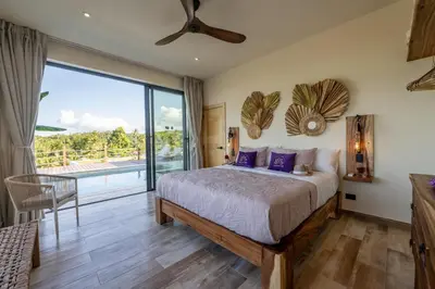 a bedroom with a bed and a large window at Villa Libelula, Ocean View, Private Pool,3 Suites in El Limón