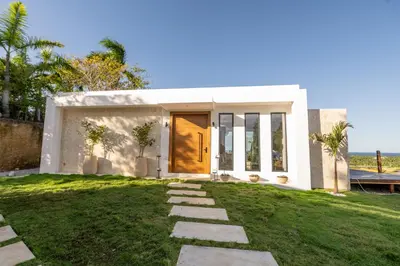 a house with a door and a grass yard at Villa Libelula, Ocean View, Private Pool,3 Suites in El Limón
