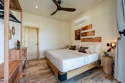 a bedroom with a bed and a ceiling fan at Villa Libelula, Ocean View, Private Pool,3 Suites in El Limón