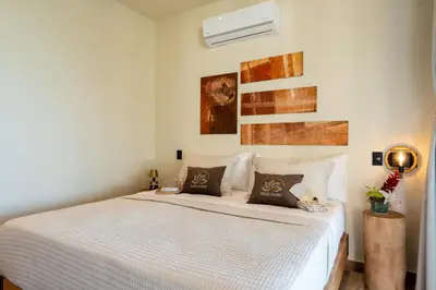 a bedroom with a large white bed with pillows at Villa Libelula, Ocean View, Private Pool,3 Suites in El Limón