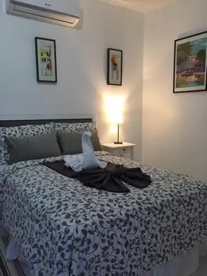 a bedroom with a bed with a robe on it at Batey Hotel Boutique in Boca Chica
