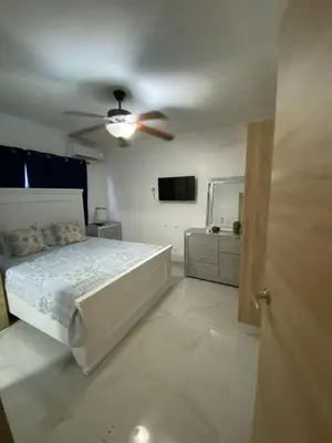 a bedroom with a bed and a ceiling fan at A space designed for you in San Cristóbal