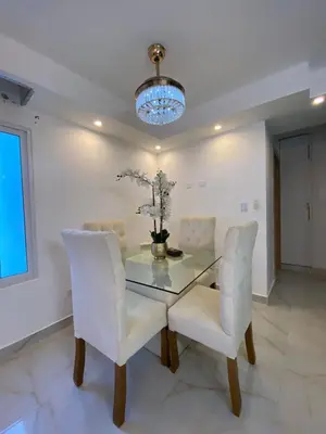 a dining room with a glass table and white chairs at A space designed for you in San Cristóbal