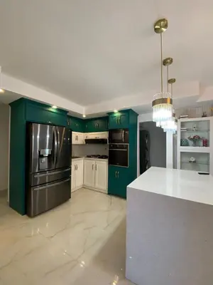 a kitchen with green cabinets and a white counter top at A space designed for you in San Cristóbal
