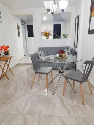 a living room with a glass table and chairs at Cozy Romance Apartment-Couples Only in Santiago de los Caballeros