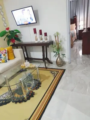 a living room with a couch and a table at Cozy Romance Apartment-Couples Only in Santiago de los Caballeros