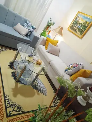 a living room with a white couch and a glass table at Cozy Romance Apartment-Couples Only in Santiago de los Caballeros