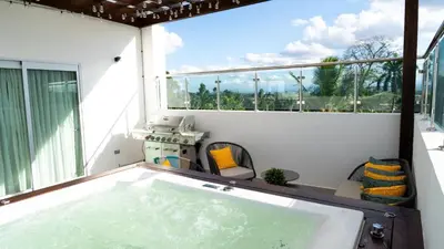 a jacuzzi tub in the balcony of a house at Luxurious 3-Bedroom Retreat in Santiago de los Caballeros in Santiago de los Caballeros