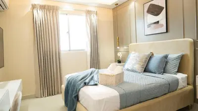 a bedroom with a bed with blue pillows and a window at Luxurious 3-Bedroom Retreat in Santiago de los Caballeros in Santiago de los Caballeros