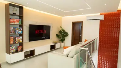 a living room with a tv on a wall at Luxurious 3-Bedroom Retreat in Santiago de los Caballeros in Santiago de los Caballeros