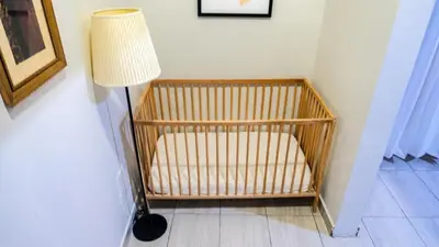 a lamp sitting next to a room with a crib at Our dreams house in Jarabacoa