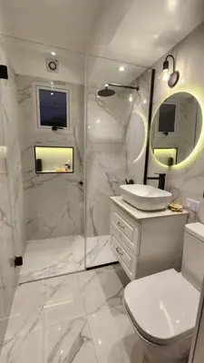a white bathroom with a sink and a shower at Apartamento paseo del bosque in Santo Domingo