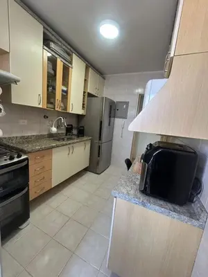 a kitchen with a sink and a refrigerator at Apartamento paseo del bosque in Santo Domingo