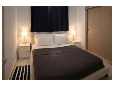 a bedroom with a large bed with two night stands at Apartement cosy et lumineux in Cuevas