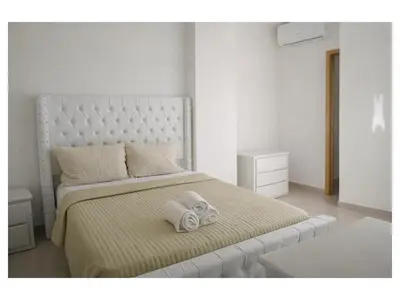 a bedroom with a bed with two towels on it at Apartement cosy et lumineux in Cuevas