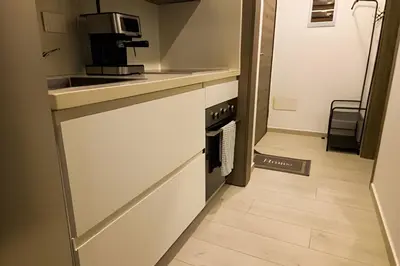a small kitchen with a sink and a stove at Condominio de lujo Salida a playa Estilo Resort Muchas comodidades: 6 piscinas/TV/aire acondicionado in Punta Cana
