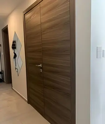a wooden door in a room with a hallway at Condominio de lujo Salida a playa Estilo Resort Muchas comodidades: 6 piscinas/TV/aire acondicionado in Punta Cana
