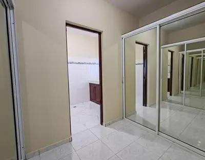 a bathroom with four mirrors and a walk in shower at Aura Azul in Sosua