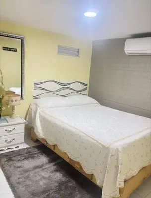 a bedroom with a bed with a mirror and a mirror at Aparta estudio Lomar II in Puerto Plata